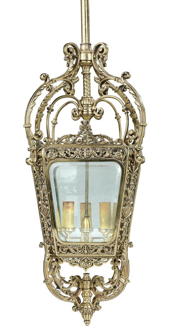 Polished Bronze and Beveled Glass Hall Lantern: Polished Bronze and Beveled Glass Hall Lantern fourth quarter 19th century, possibly French, the tapered lantern framed with pierced scrollwork and matching crests, supported both above and below with