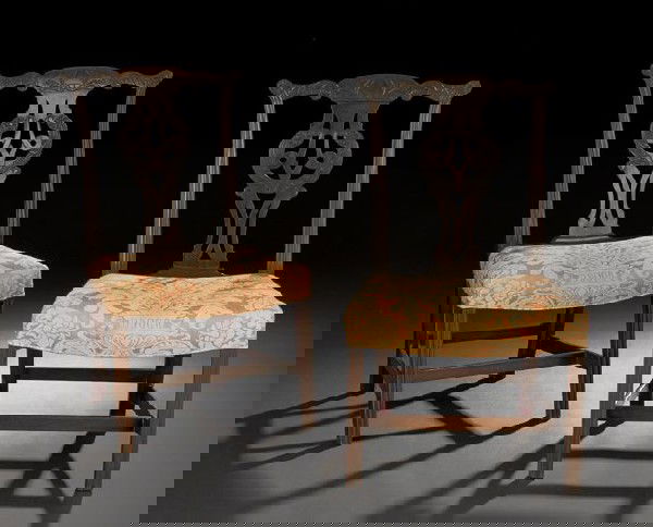 Pair of George III Mahogany Sidechairs: Pair of George III Mahogany Sidechairs, late 18th century, in the style of Thomas Chippendale, each with a shaped and earred foliate-carved crest above a like-carved pierced and interlacing splat, the