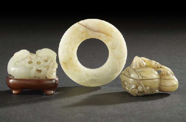 Chinese White Jade Bi Disk and Two Jade Toggles: Chinese White Jade Bi Disk and Two Jade Toggles, the disk carved in low relief on the face with two hydra dragons, the reverse with low-relief carving of "C" scrolls, presented in a silk brocade box; 