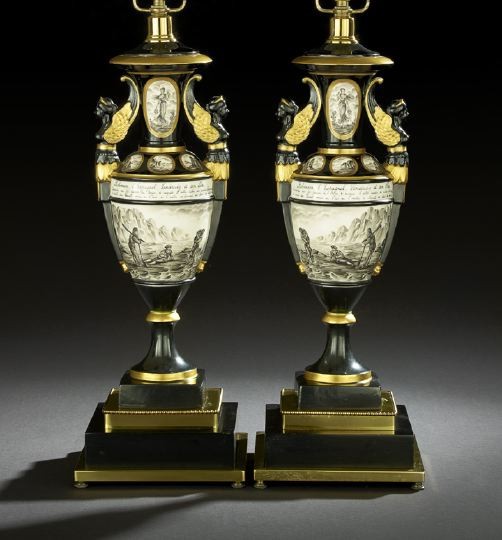 Pair of Porcelain de Paris Garniture Vases: Pair of Porcelain de Paris Black-Ground Porcelain Garniture Vases, second quarter 20th century, in the Restauration style, each with grisaille reserves from "Robinson Crusoe", the handles modeled as p
