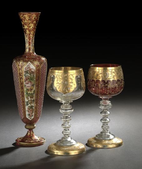 Three-Piece Group of Bohemian Glass: Three-Piece Group of Bohemian Glass, fourth quarter 19th century, consisting of a graceful Bohemian richly gilded, polychromed and cut lattimo-over-cranberry overlay glass garniture vase attributed to