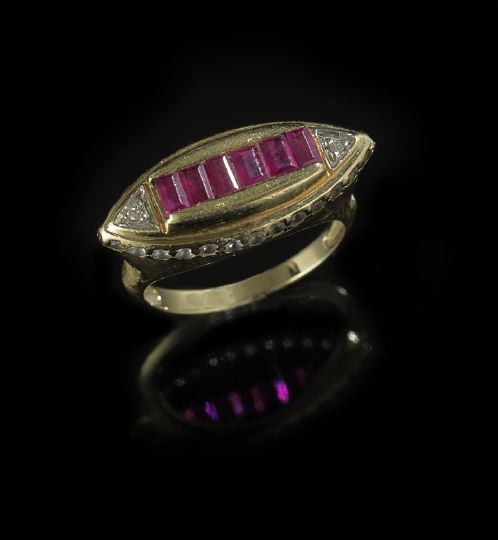 18 Kt. Gold, Ruby and Diamond Saddle-Shaped Ring: Eighteen-Karat Yellow Gold, Ruby and Diamond Saddle-Shaped Ring, composed of six channel-set calibre-cut rubies in a navette mounting set with accent diamonds on the top and bordering on the sides.