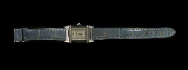 Lady's Jaeger-LeCoultre Reverso Wristwatch: Lady's Jaeger-LeCoultre Diamond Reverso Wristwatch, the squared stainless steel body with diamond-set border, the mother-of-pearl face with diamond-set numerals, on a leather strap, accompanied by the
