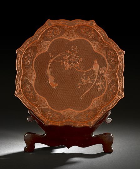 Chinese Cinnabar Lacquer Plate: Chinese Cinnabar Lacquer Plate, early 20th century, of shaped lobed outline, well carved with a central design of two long-tailed birds and a flowering rose, the well walls decorated with panels of co