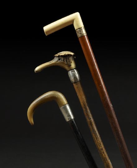 Three Edwardian Canes: Three Edwardian Canes, first quarter 20th century, including an ebony example with buffalo horn "crutch" handle, brass tip and sterling silver ferrule hallmarked Birmingham, the date letter rubbed, by
