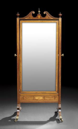 Edwardian Mahogany Cheval Mirror: Edwardian Mahogany Cheval Mirror, ca. 1900, the broken swan's-neck crest centered by a brass ball finial with side urn-form accents, the long beveled rectangular plate supported by bellflower-inlaid u