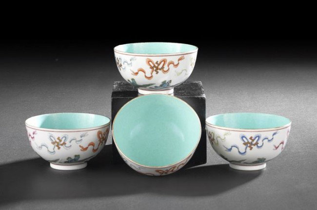 Four Chinese Famille Rose Porcelain Tea Bowls: Set of Four Chinese Famille Rose Porcelain Tea Bowls, second half 19th century, each decorated with six Buddhist swastikas with flowing ribbons above rockwork rising out of cresting waves, the interio
