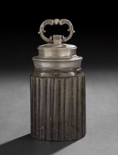 Continental Pewter-Mounted Serpentine Humidor: Continental Pewter-Mounted Serpentine Humidor, fourth quarter 18th century, of columnar form, the lignum vitae body flute-carved, the pewter screw-top with a handle of addorsed scroll form, h. 8", dia