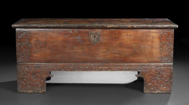 Continental Oak and Fruitwood Coffer: Continental Oak and Fruitwood Coffer, late 18th century, the hinged rectangular top opening to a void interior, the front with a decorative iron escutcheon and side relief-carved foliate designs, rais