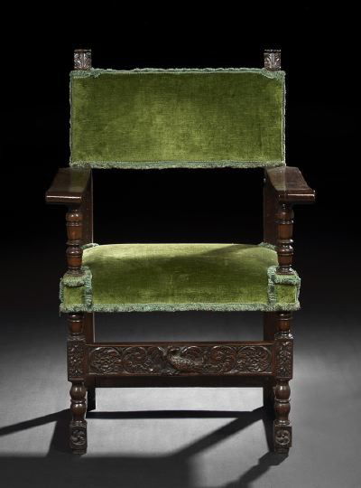 Iberian Walnut Hall Chair: Iberian Walnut Hall Chair, late 18th century, the padded rectangular back with corner foliate finials, joined by flat arms on turned uprights to the padded seat, raised on bulbous legs joined by a fol