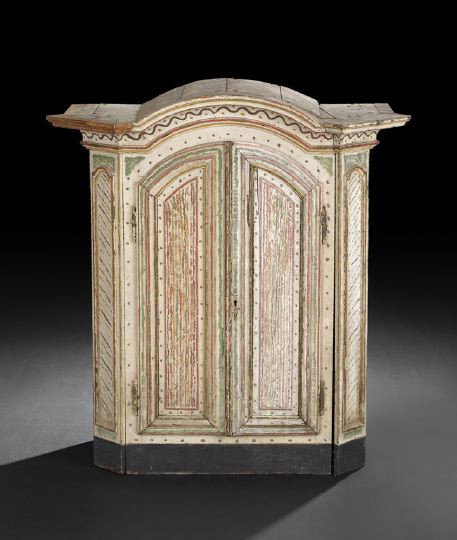 Continental Provincial Polychromed Cabinet: Continental Provincial Polychromed Cabinet, early 19th century, the domed and molded cornice with canted corners above a conforming case fitted with two arched and paneled doors, the sides also panele