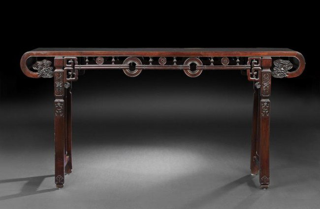 Large Chinese Rosewood Altar Table: Large Chinese Rosewood Altar Table, mid-20th century, the rectangular body with downturned ends, central floating panel, carved and pierced apron with cloud terminals, archaic fretwork and bi disks, a