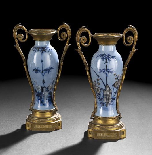 Diminutive Pair of Tung Chih Blue Porcelain Vases: Diminutive Pair of Tung Chih Blue Porcelain Vases, third quarter 19th century, of baluster form, mounted in gilt-brass in the Louis XVI style to form a pair of two-handled garniture vases, the porcela