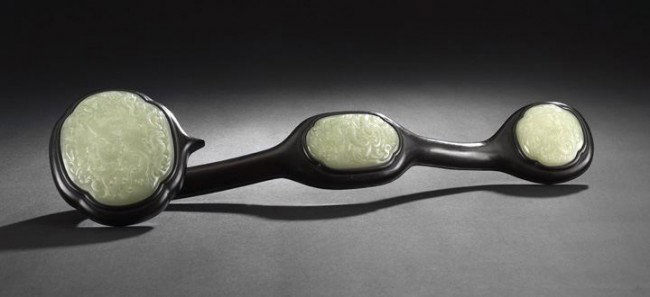 Chinese Carved Jade and Rosewood Ruyi Scepter: Chinese Carved Celadon Jade and Rosewood Ruyi Scepter, 19th century and later, composed of three lobed oval reticulated and domed celadon jade plaques, each of even tone and carved as sinuous scaled d
