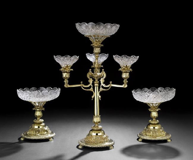 English Gilt-Metal Three-Piece Table Garniture: English Gilt-Metal Three-Piece Table Garniture, contemporary, including a large epergne with a central tapering standard raised on a domed base supported by three demi-lions affronte, above a circular
