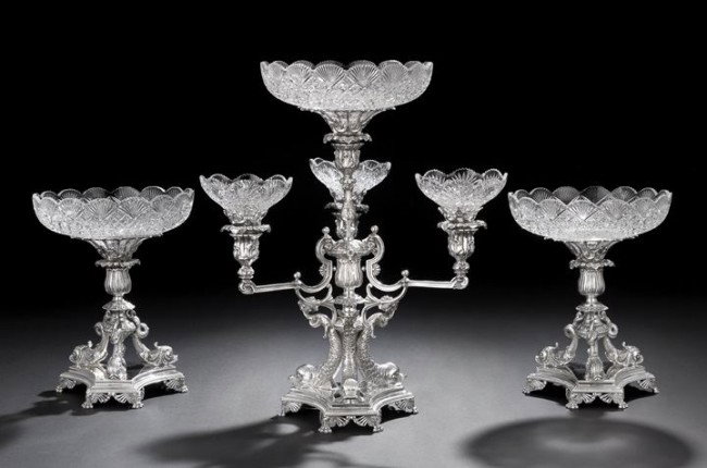 English Silverplate Three-Piece Table Garniture: English Silverplate Three-Piece Table Garniture, contemporary, including a large epergne/candelabrum with a central floriform knopped standard raised on three dolphin supports above a canted and cavet