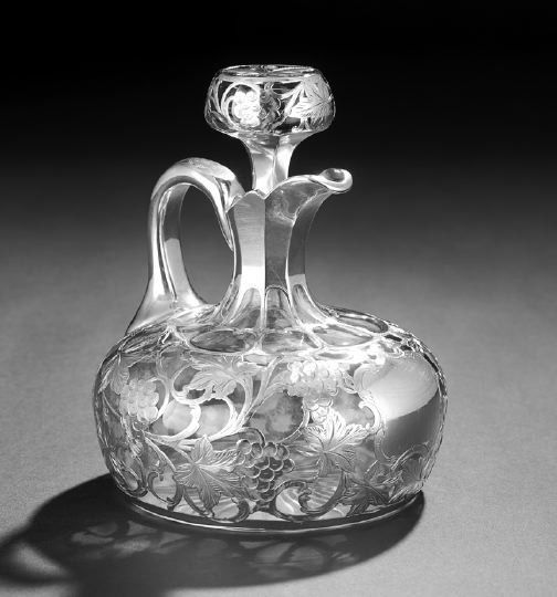 Alvin Silver Deposit Glass Whiskey Decanter: Alvin Silver Deposit Glass Whiskey Decanter, ca. 1900, by the Alvin Mfg. Co., Sag Harbor, New York, the glass body of flattened spherical form with fluted neck and arched handle, the bottom with starb