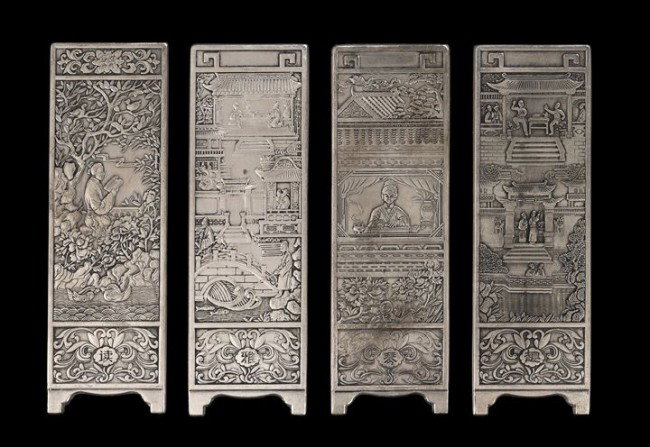 Group of Four Chinese Silver Miniature Panels: Group of Four Chinese Silver Miniature Panels, each cast as a panel of a standing floor screen depicting figures in gardens and pavilions, probably cast as scroll weights for holding open hand scrolls