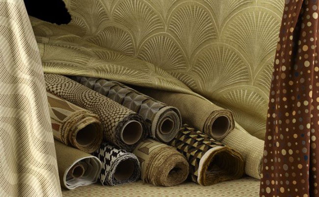 13 Rolls of Schumacher and Other Assorted Fabrics: Thirteen Rolls of Schumacher, Clarence House and Other Assorted Modern and Contemporary Fabrics, including a Kravet Couture petit point tapestry "Epingle" pattern in brown, black and tan tones, w. 55"