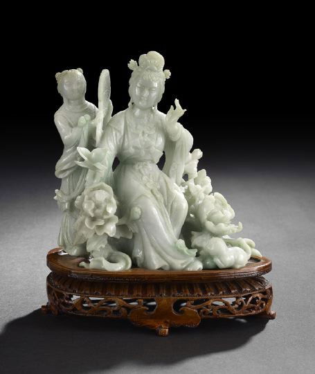 Chinese Jade Group of a Female Deity & Attendant: Chinese Carved Jade Group of a Female Deity and Attendant, 20th century, the deity seated in elaborate robes among peonies with a kitten at her feet and having a female attendant standing at her side