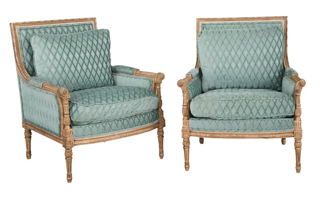 Pair of Louis XVI-Style Giltwood Bergeres: Pair of Louis XVI-Style Giltwood Bergeres each with a beaded back joined to fluted and closed arms, the seat with a loose cushion, bowed seat rail and segmented, fluted legs. h. 36", w. 31", d. 30-1/2