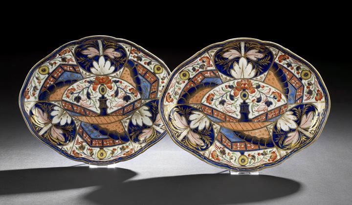 Pair of Oval Signed Imari-Style Derby Dishes: Pair of Oval Signed Imari-Style Derby Dishes, 1806-1810, the central decoration of a navy vase of flowers in a fan shaped panel, marked with a red hand painted crown over AD, d. 8", l. 9-3/4".