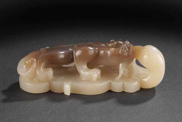 Chinese Carved Cream and Brown Jade Group: Unusual Chinese Carved Cream and Brown Jade Group, 19th century, carved as a brown hydra dragon with bifurcated tail confronting the head of a crane rising from below and holding a spray of ling-chih 