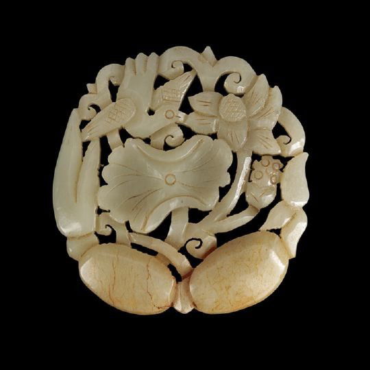 Chinese Carved Celadon Jade Pendant: Chinese Carved Celadon Jade Pendant, late 19th century, carved and pierced of oval outline as a bird among lotus with flowers, seed pod, leaves and tubers, the celadon colored stone with russet inclus