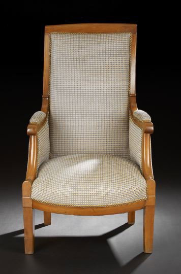 Charles X Walnut Bergere: Charles X Walnut Bergere, mid-19th century, the tall padded rectangular back surmounted by a curved crest, joined by closed arms to the padded seat, raised on saber legs, h. 48".