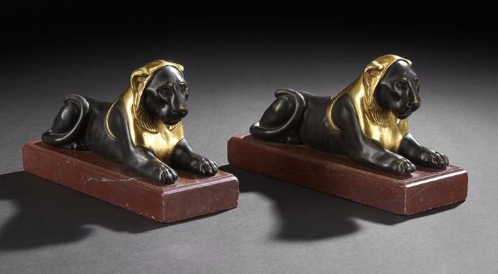 Pair of Bronze Figures of the Capitoline Lioness: Pair of Empire Patinated and Burnished Bronze Figures of the Capitoline Lioness, second quarter 19th century, each recumbent and mounted to a red quartzite marble base, h. 5", w. 9-1/2", d. 3". Proven