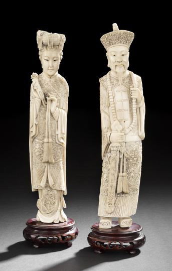 Pair Chinese Ivory Carved Figures: Pair Chinese Ivory Carved Figures of an Emperor and Empress, 20th century, each carved in formal court dress, the emperor holding a sword, the empress holding a ruyi scepter, wooden stands, h. 13-1/2"
