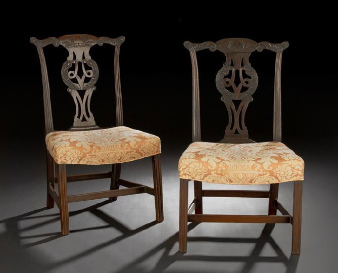 Pair of George III Mahogany Sidechairs: Pair of George III Mahogany Sidechairs, late 18th century, in the style of Thomas Chippendale, each with a shaped and earred foliate-carved crest above a like-carved pierced and interlacing splat, the