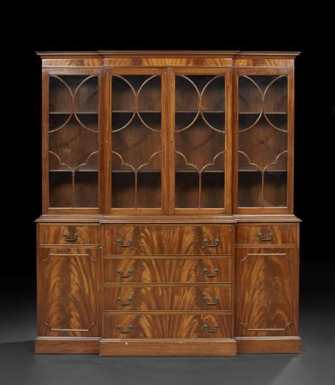 George III-Style Mahogany Breakfront Bookcase: George III-Style Mahogany Breakfront Bookcase, mid-20th century, the molded and dentillated cornice above four astragal-glazed doors, the lower section fitted with a drop-front secretary opening to a 