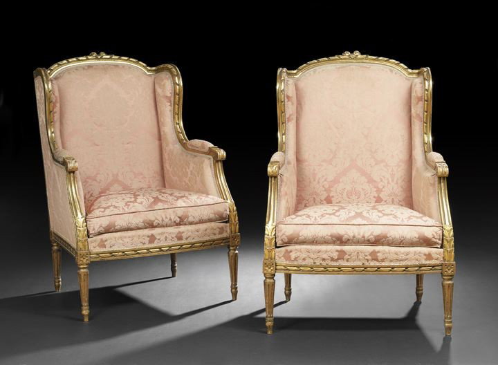 Pair of Louis XVI-Style Giltwood Bergeres: Pair of Louis XVI-Style Giltwood Bergeres-avec-Orielles, third quarter 19th century, each with a padded and domed back surmounted by a floral crest and within a rope-carved frame, joined to the cushio
