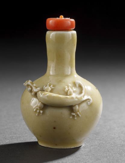 Chinese Molded Porcelain Snuff Bottle: Chinese Molded Porcelain Snuff Bottle, the bulbous body with elongated neck and the figure of a hydra dragon with bifurcated tail in high relief, all under a greenish yellow glaze, h,. 2-3/4".