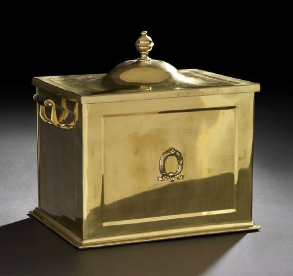 Polished Brass Edwardian Kindling Box: Polished Brass Edwardian Kindling Box, first quarter 20th century, in the neoclassical style, with an applied wreath on its facade and turned wooden handles, fitted with a heavy sheet-iron liner, h. 1