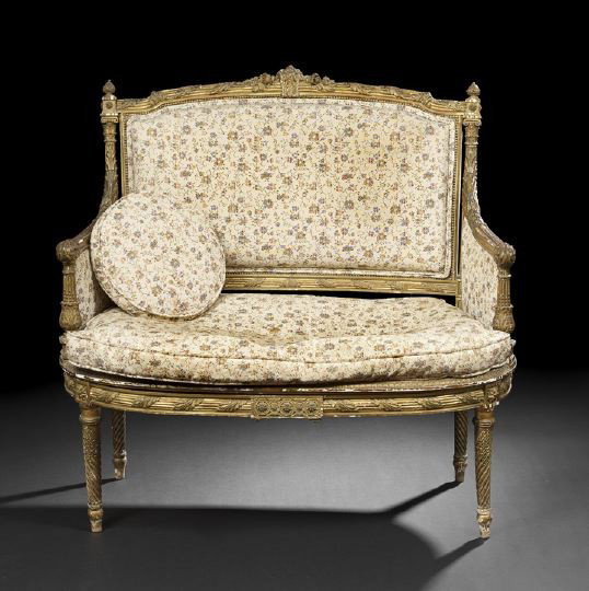 Louis XVI-Style Giltwood Settee: Louis XVI-Style Giltwood Settee, fourth quarter 19th century, the domed and padded rectangular back surmounted by a floral acanthine crest, joined by closed arms on foliate fluted uprights to the cush