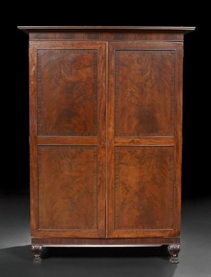 American Classical Mahogany Armoire: American Classical Mahogany Armoire, early 19th century, New York, the projecting reeded cornice over a pair of doors with bisected banded panels, the doors opening to a medial belt of three over two 