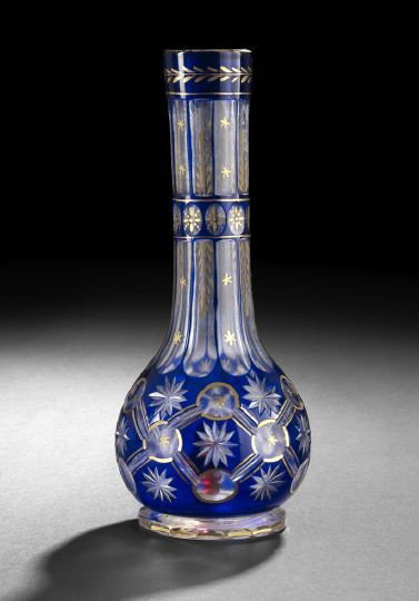 Cobalt Overlay and Cut-to-Clear Hobble Bobble: Cobalt Overlay and Cut-to-Clear Hobble Bobble, first quarter 20th century, a Middle Eastern water pipe used for smoking tobacco, this example is cut with stars and has applied gilt outlines, h. 11-1/8