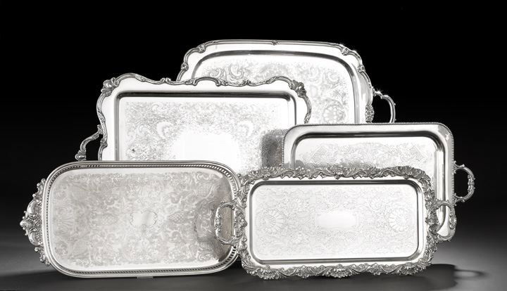 Five American Rectangular Silverplate Trays: Five American Rectangular Silverplate Trays, mid-20th century, all with rococo-engraved plateau, including an unmarked drinks tray with shell-and-scroll rim, 11" x 25", a Wallace Silversmiths gallerie