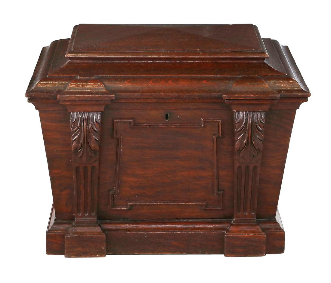 George III Stained Oak Cellarette: George III Stained Oak Cellarette early 19th century, the stepped top hinged and opening to a metal-lined interior, the slightly tapering body with a paneled front flanked by fluted acanthine-carved u