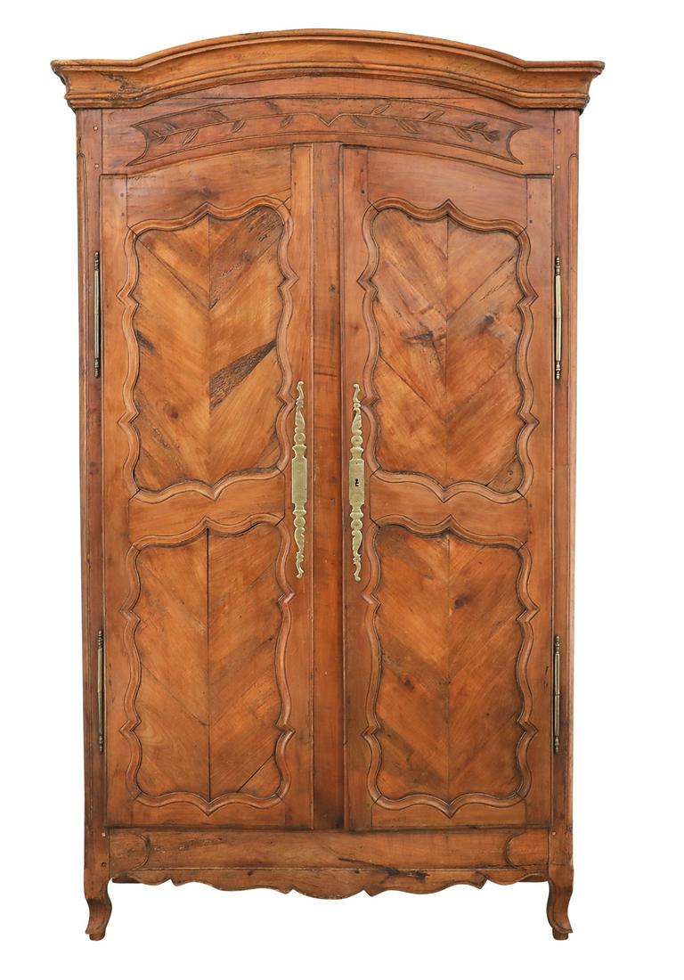 Provincial Louis XV Fruitwood Armoire: Provincial Louis XV Fruitwood Armoire late 18th century, the molded bonnet cornice over a leaf- and vine-carved frieze, the pair of doors with shaped parquetry panels, raised on cabriole legs. h. 92-1
