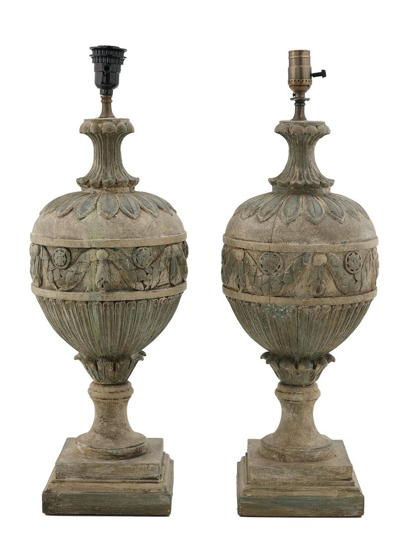 Pair of Carved and Painted Wooden Urn-Form Lamps: Pair of Carved and Painted Wooden Urn-Form Lamps in the neoclassical taste, the bodies decorated with swagging over long leaf carving, the inverted necks with design to match, on molded, square bases.
