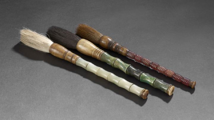 Group of Three Chinese Calligraphy Brushes,: Group of Three Chinese Calligraphy Brushes, each with bodies made of shaped hardstone pieces with bone bases and tops and horsehair bristles, l. 12".