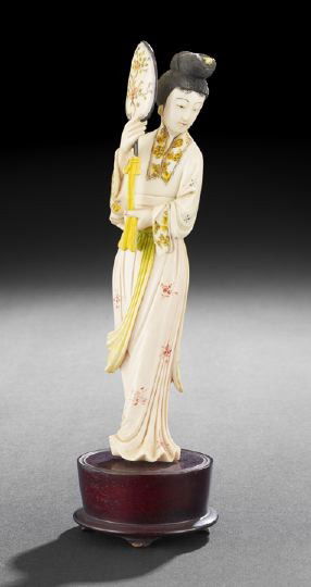 Chinese Ivory Figure of a Court Entertainer: Chinese Carved and Painted Ivory Figure of a Court Entertainer, the standing figure clad in dancer's robes with an elaborate hairdo and holding a tasseled fan, wooden stand, h. 9-1/2".