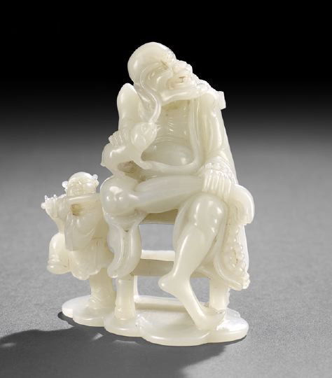 Chinese Carved White Jade Figural Group,: Chinese Carved White Jade Figural Group, the slightly greenish white stone intricately carved as a sage seated in a bamboo side chair holding a small dog and accompanied by a flute playing, dancing ch