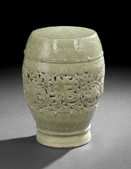 Chinese Celadon Glazed Porcelain Garden Seat,: Chinese Celadon Glazed Porcelain Garden Seat, 19th century, of barrel-form with molded floral bosses, pierced floral decoration and incised scrolling foliage design in the body, h. 19".