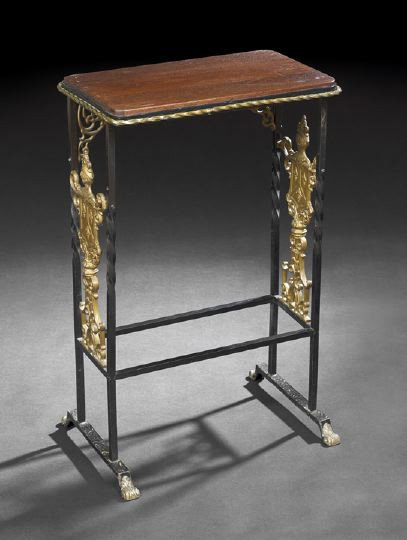Edwardian Mahogany and Gilt Metal Table: Edwardian Mahogany and Wrought and Gilt Metal Occasional Table, early 20th century, the rounded rectangular top within a twisted gilt boarder, raised on wrought iron supports joined by side shield-for