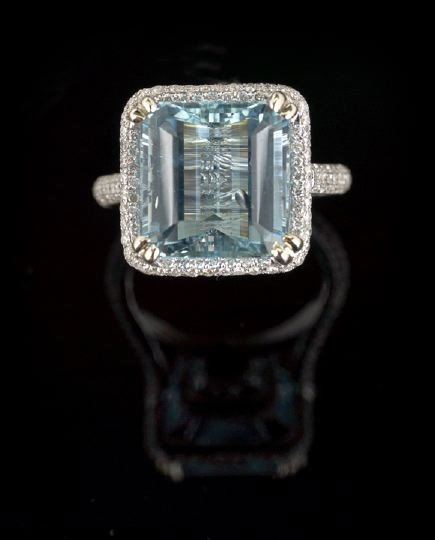 18 Kt. White Gold, Aquamarine and Diamond Ring: Lady's Eighteen-Karat White Gold, Aquamarine and Diamond Ring, composed of a central square step-cut aquamarine weighing 6.71 carats set in a diamond encrusted mount and shank, estimated total diamond