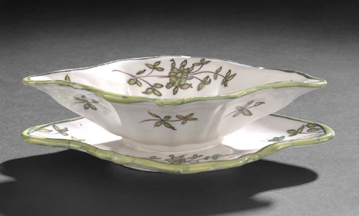 Faience Sauce Boat on Stand,: Faience Sauce Boat on Stand, third quarter 19th century, decorated with hand painted green flowers and borders with stand attached, h. 3", w. 5-1/2", l. 10".